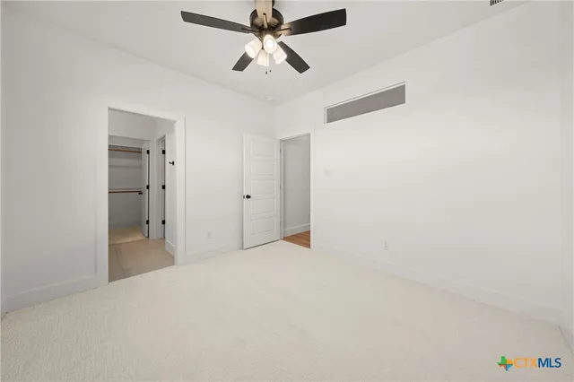a view of empty room with ceiling fan