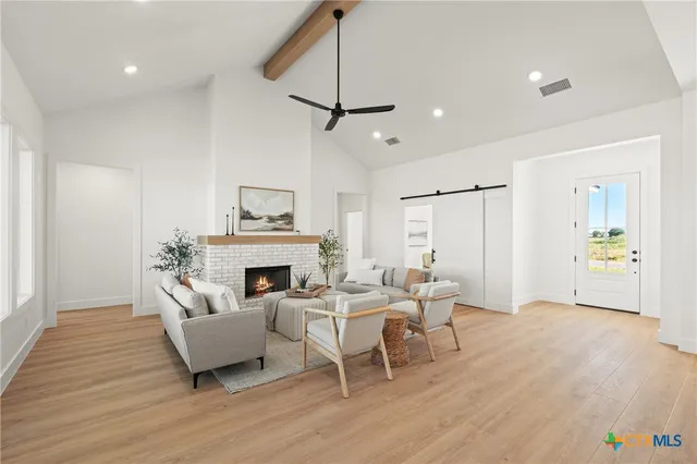 a living room with furniture a fireplace and a chandelier