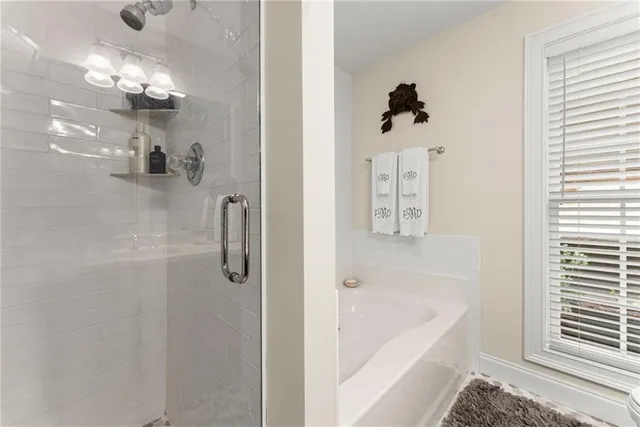 a bathroom with a bathtub and shower