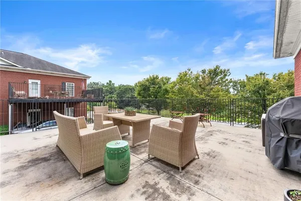 a view of a patio with couches and potted plants