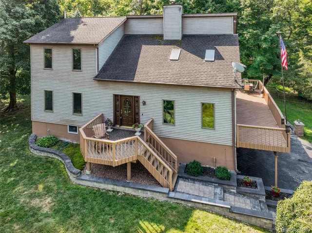 a view of a house with a yard and furniture