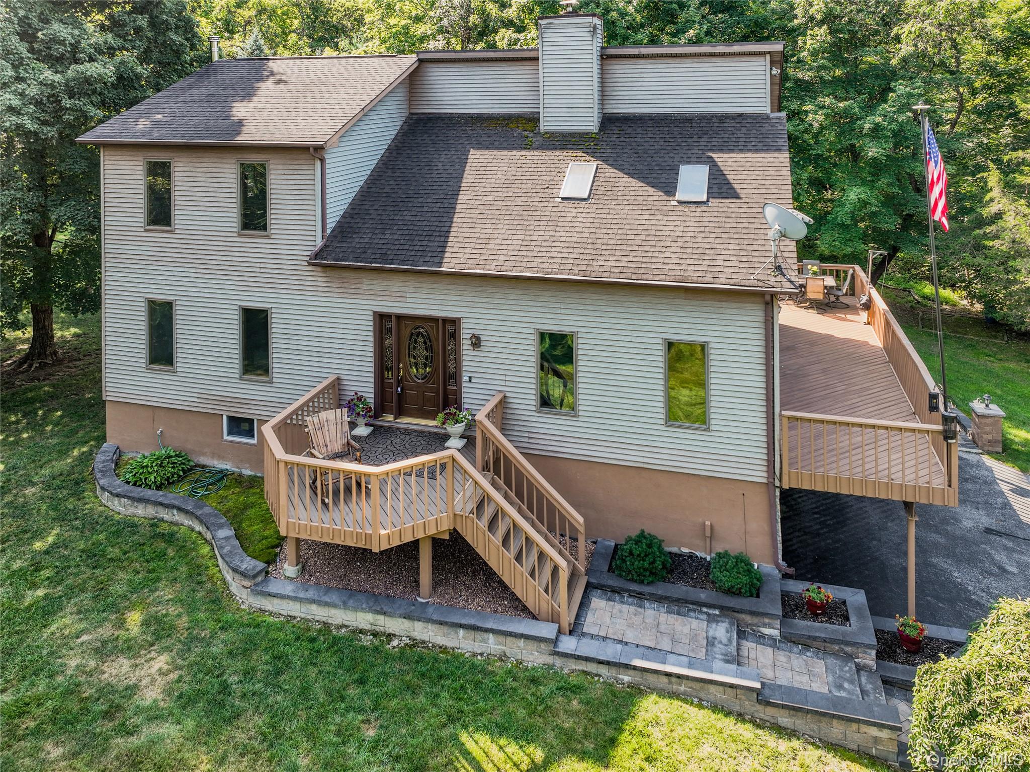 a view of a house with a yard and furniture