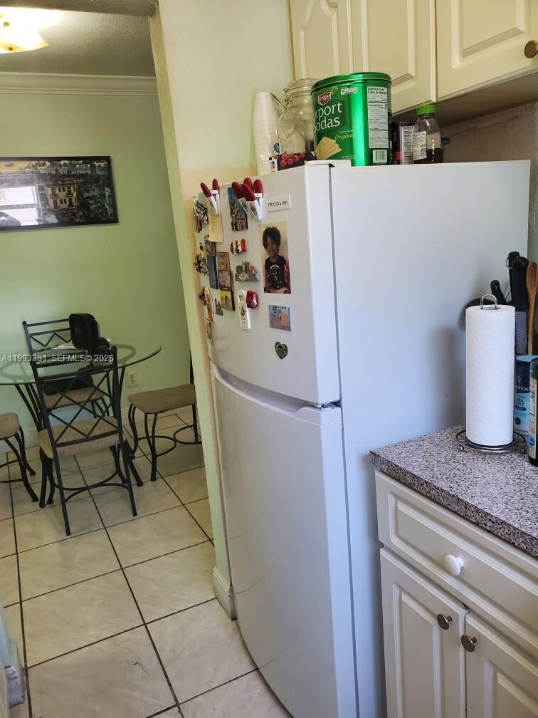 3901 Southwest 78th Court, Unit 221 Miami, FL 33155 - Photo 12 of 13 a white refrigerator freezer sitting inside of a kitchen