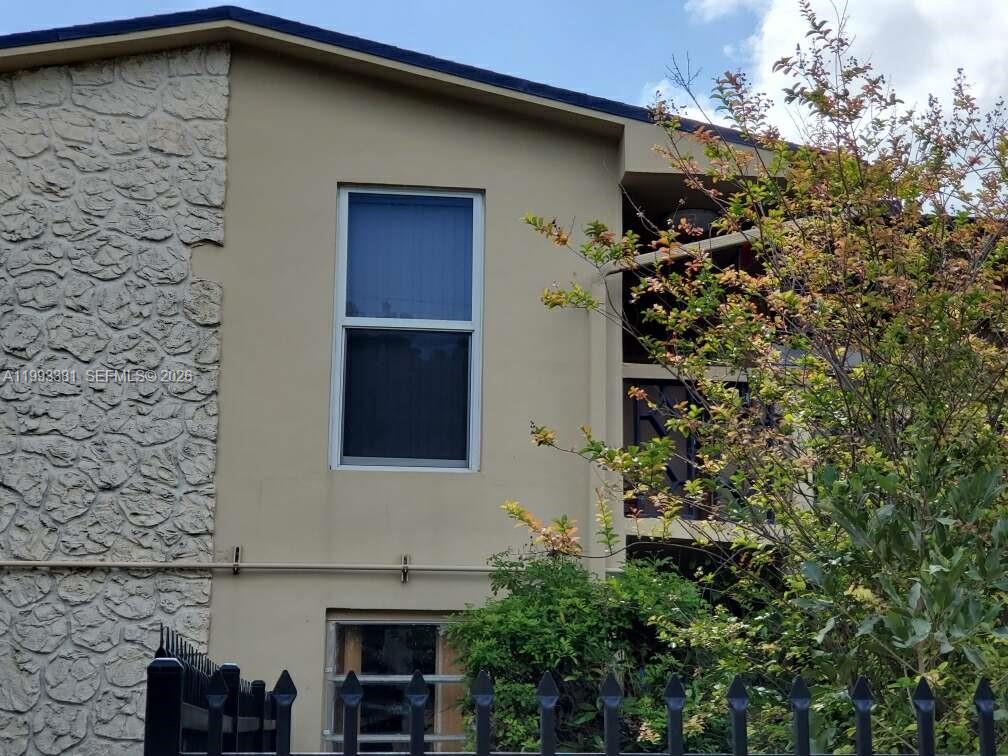 3901 Southwest 78th Court, Unit 221 Miami, FL 33155 - Photo 2 of 13 a front view of a house with a yard