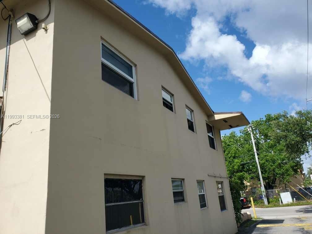 3901 Southwest 78th Court, Unit 221 Miami, FL 33155 - Photo 3 of 13 a front view of a house with a yard