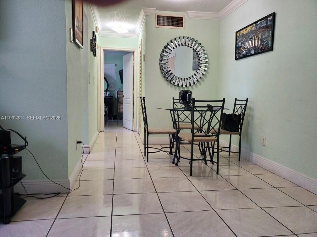 3901 Southwest 78th Court, Unit 221 Miami, FL 33155 - Photo 5 of 13 a view of a room with a table and chairs