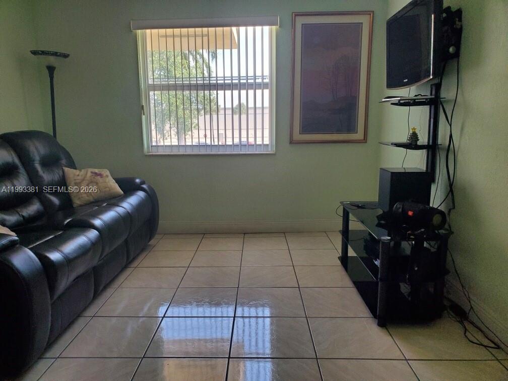 3901 Southwest 78th Court, Unit 221 Miami, FL 33155 - Photo 6 of 13 a living room with furniture and a window