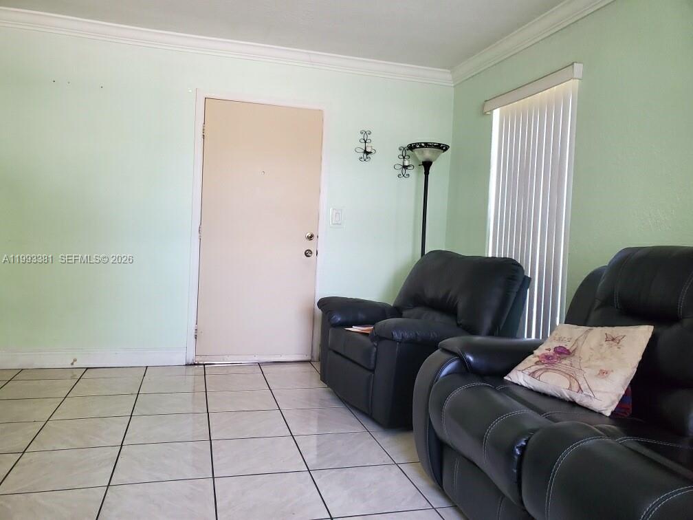 3901 Southwest 78th Court, Unit 221 Miami, FL 33155 - Photo 7 of 13 a living room with furniture and a rug