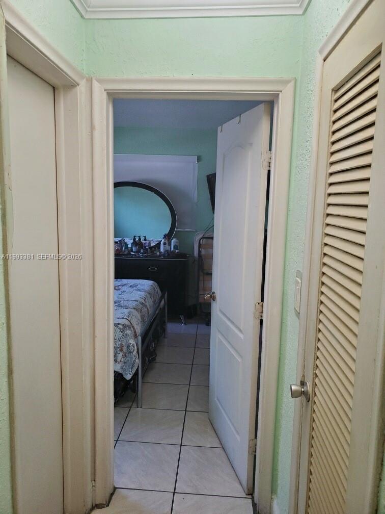 3901 Southwest 78th Court, Unit 221 Miami, FL 33155 - Photo 8 of 13 a bedroom with a bed and a mirror