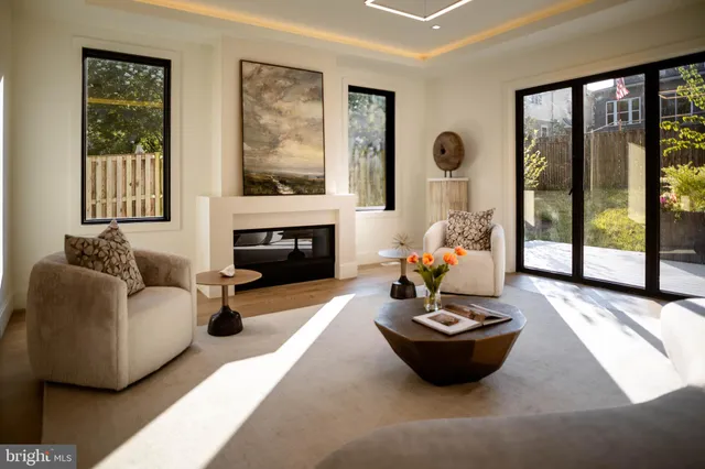 a living room with furniture and a painting on the wall