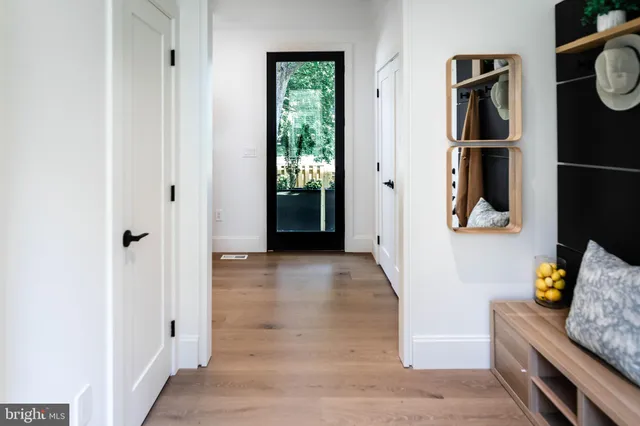 a hallway with painting and stairs