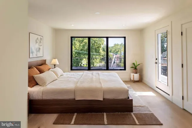a bed sitting in a bedroom next to a large window