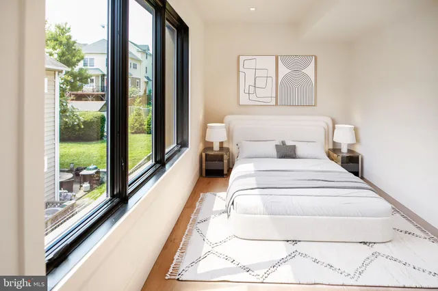 a bedroom with a bed and a potted plant