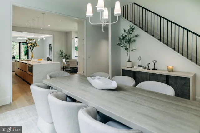 a dining room with furniture and a chandelier