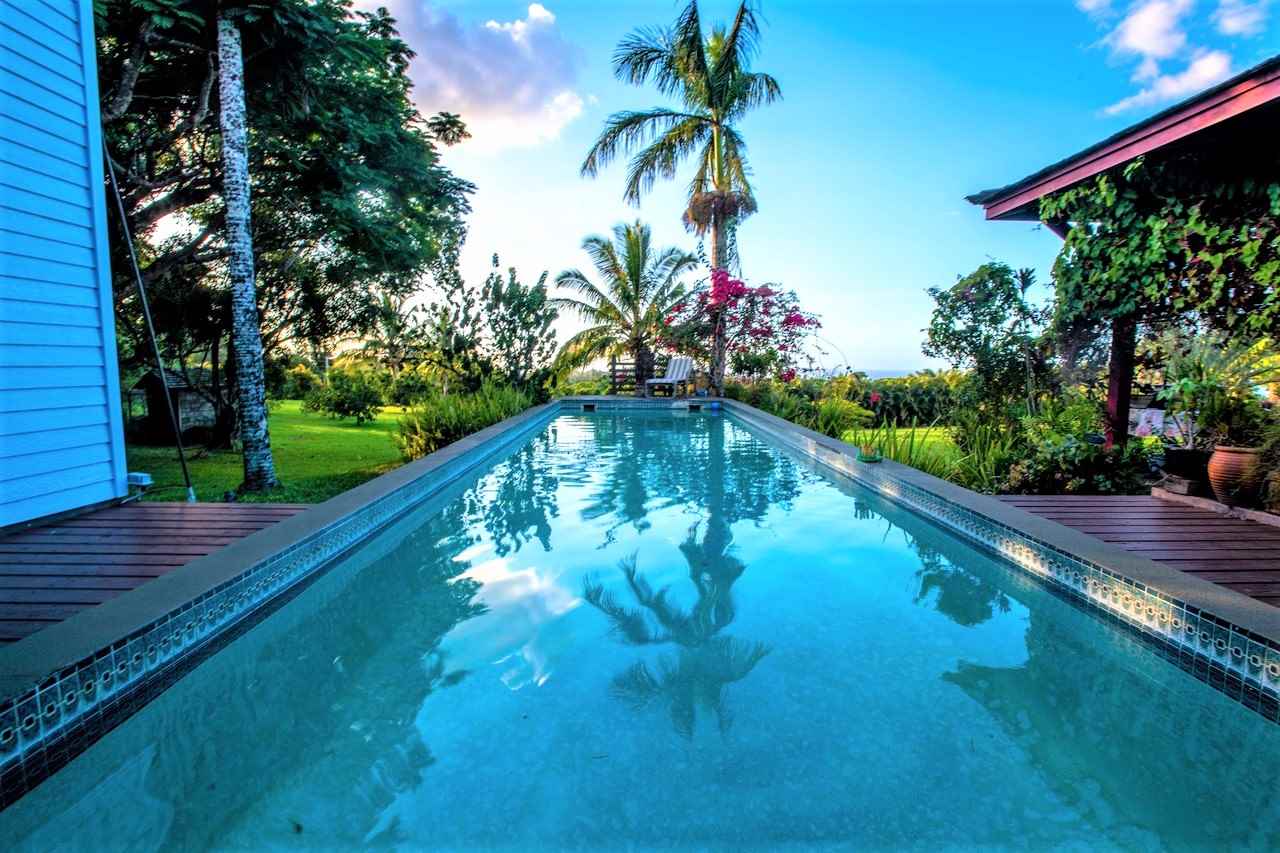 941 Hog Back Road Haiku, HI 96708 - Photo 7 of 18 a view of a swimming pool with a garden