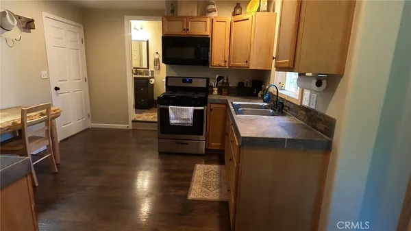 a kitchen with a refrigerator and a stove