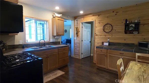 a kitchen with wooden cabinets and a stove top oven