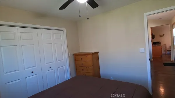 a bathroom with a toilet sink vanity and mirror
