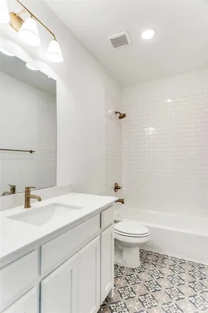 a bathroom with a sink a toilet and a large mirror