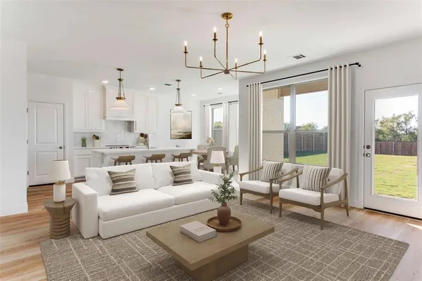 a living room with furniture and a chandelier