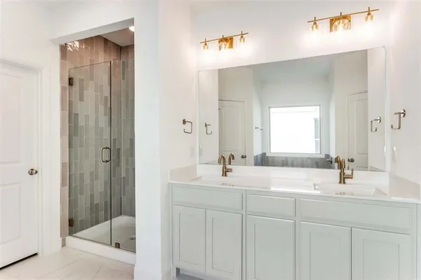 a bathroom with double sink and a mirror