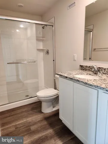 a bathroom with a toilet a sink and shower