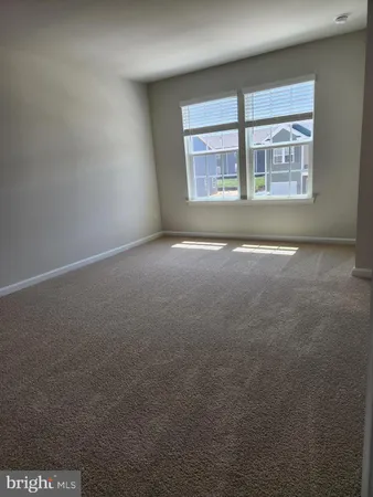 an empty room with a empty space and windows