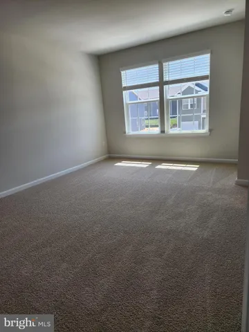 an empty room with a empty space and windows