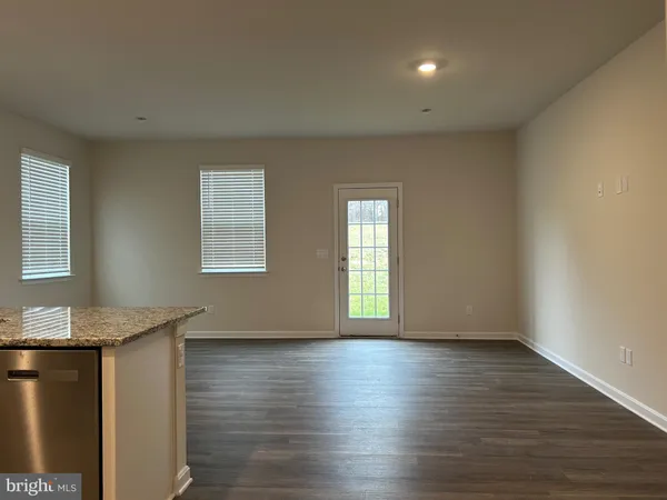 a room with wooden floors and window