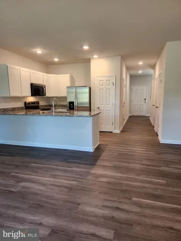 a view of kitchen and kitchen with stainless steel appliances