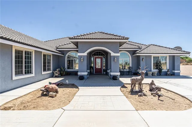a view of a house with backyard outdoor seating area and furniture