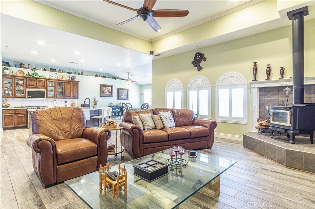 9735 Elsinore Road Oak Hills, CA 92344 - Photo 12 of 64 a living room with furniture ceiling fan and a rug
