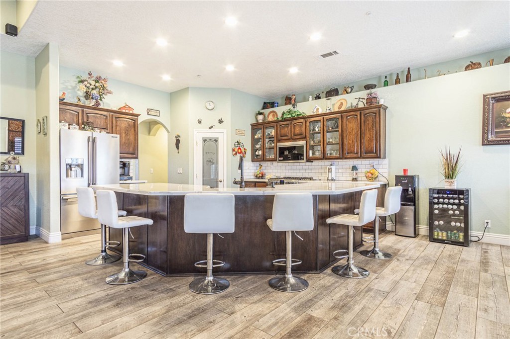9735 Elsinore Road Oak Hills, CA 92344 - Photo 13 of 64 a large kitchen with a table and chairs