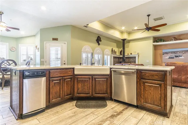 a dinning room with kitchen island furniture a fireplace and a sink