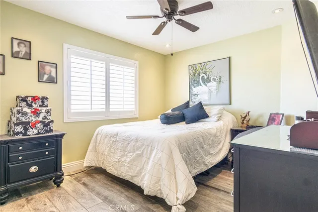 a bedroom with a bed and a large mirror