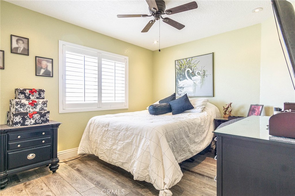9735 Elsinore Road Oak Hills, CA 92344 - Photo 19 of 64 a bedroom with a bed and window
