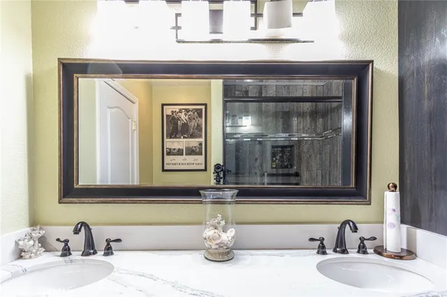 a bathroom with a toilet sink vanity and mirror