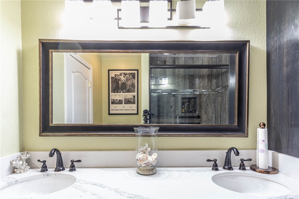 9735 Elsinore Road Oak Hills, CA 92344 - Photo 24 of 64 a bathroom with a sink and a mirror