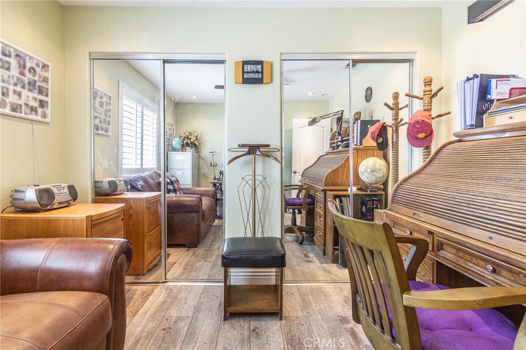 9735 Elsinore Road Oak Hills, CA 92344 - Photo 27 of 64 a living room with furniture and a flat screen tv