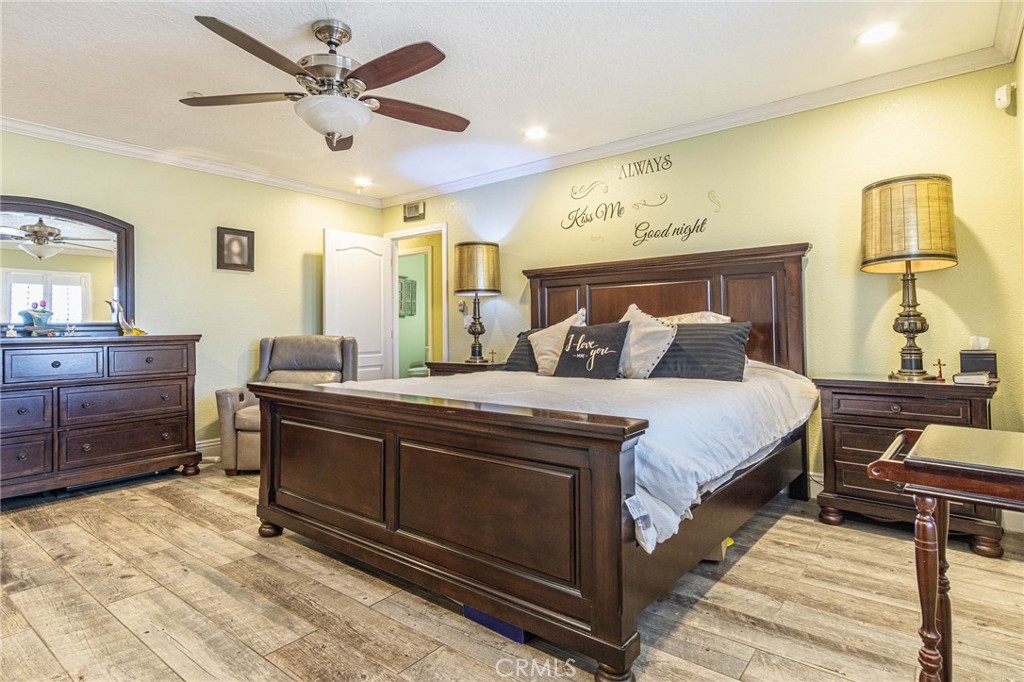 9735 Elsinore Road Oak Hills, CA 92344 - Photo 30 of 64 a bedroom with a bed and a dresser