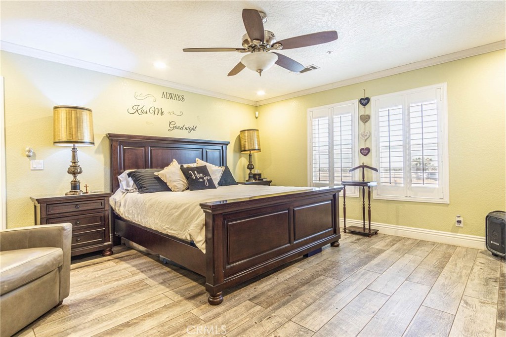 9735 Elsinore Road Oak Hills, CA 92344 - Photo 31 of 64 a bed room with a bed and a couch