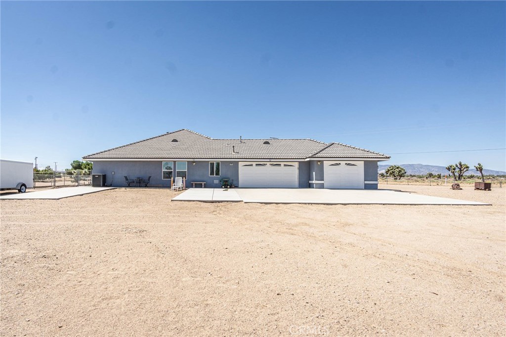 9735 Elsinore Road Oak Hills, CA 92344 - Photo 59 of 64 a front view of a house with a yard