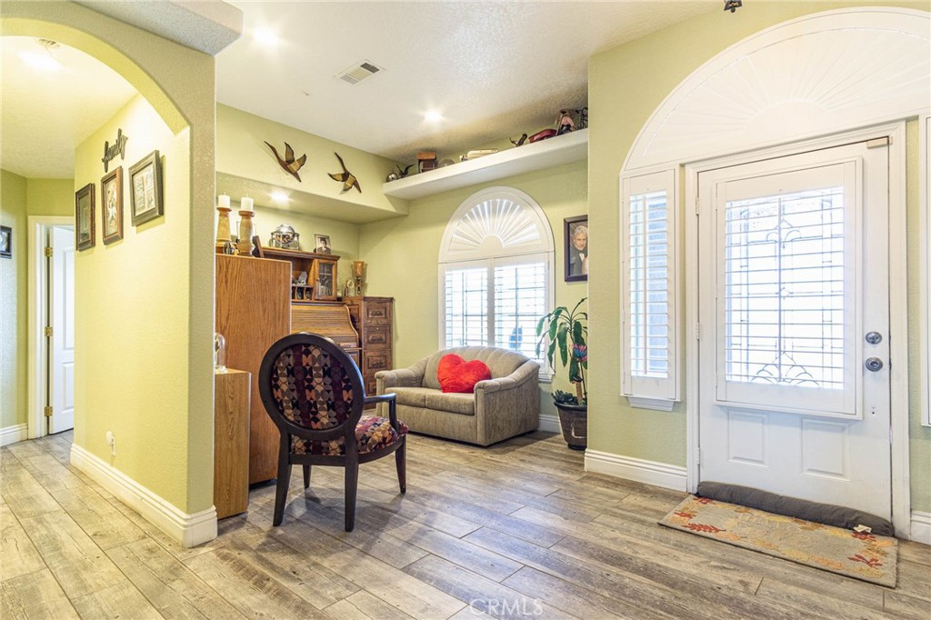 9735 Elsinore Road Oak Hills, CA 92344 - Photo 7 of 64 a living room filled with furniture and a floor to ceiling window