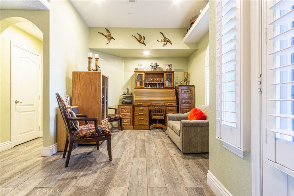 9735 Elsinore Road Oak Hills, CA 92344 - Photo 9 of 64 a living room with furniture and a chandelier
