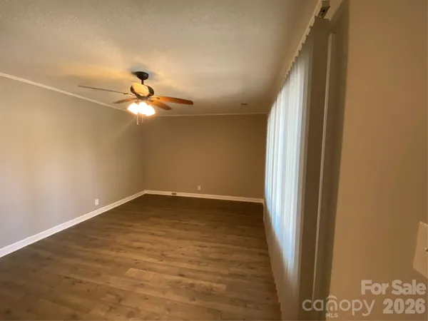 a view of a room with wooden floor