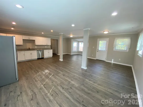 a view of a kitchen with a sink and dishwasher cabinets