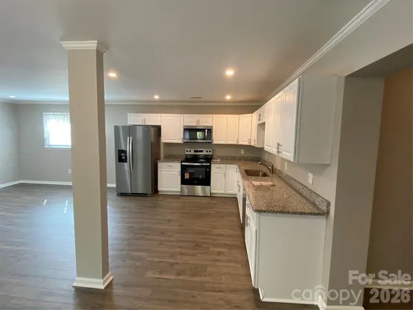 a view of a kitchen with a sink and refrigerator