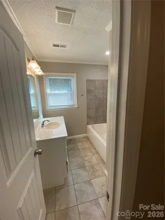 a view of a bathroom with a sink and mirror