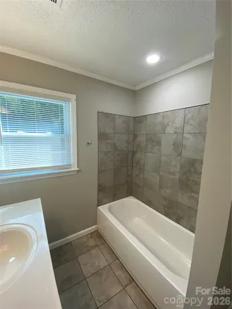 a bathroom with a bathtub and shower