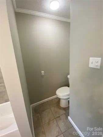 a white toilet sitting next to a shower